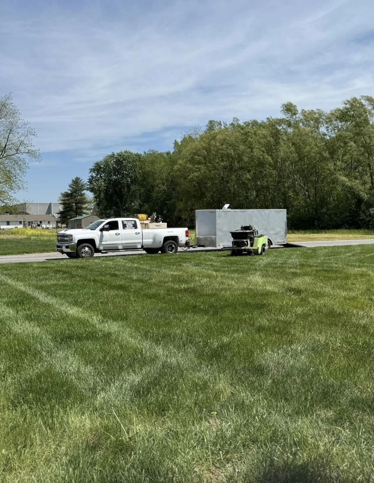 DeBloois Landscaping truck and trailer parked at a Delaware property